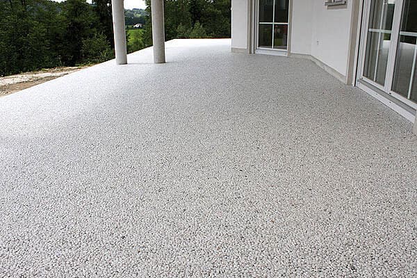 Weißer Steinteppich auf großer Terrasse mit Säulen